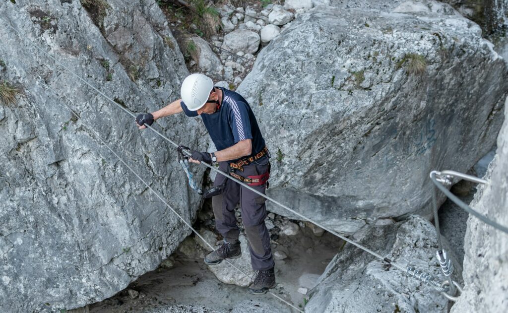 Elderly man climbing the via ferrata