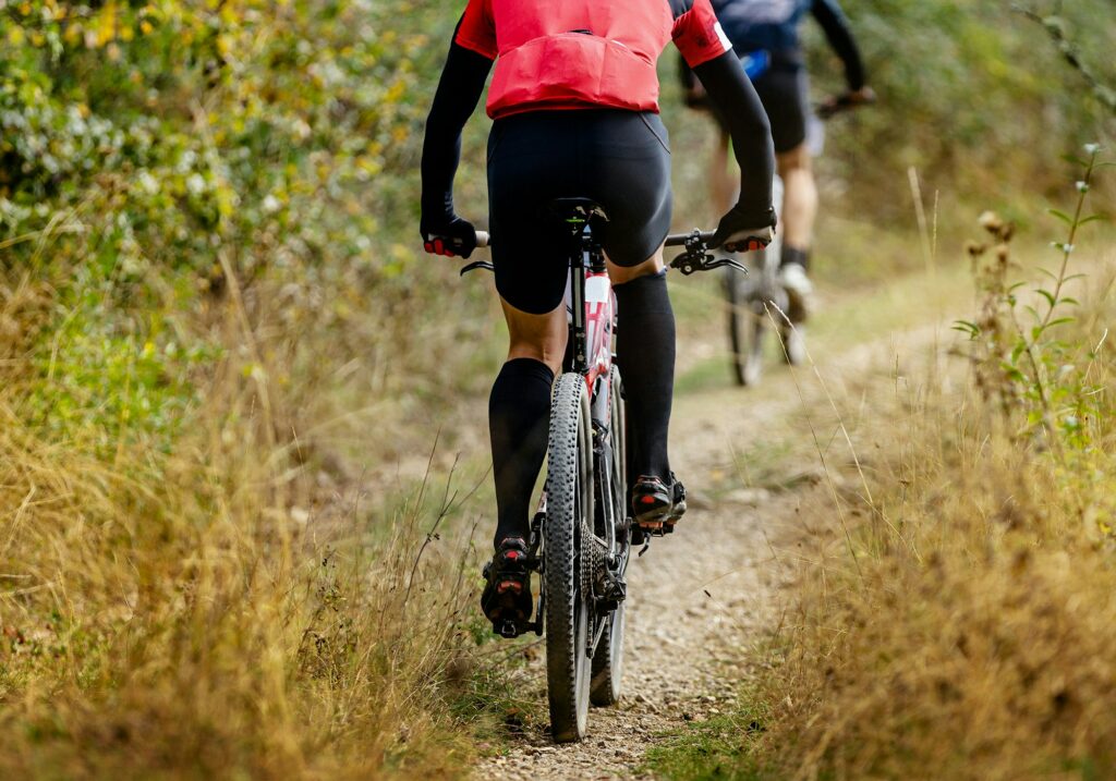 rear wheel sports mountain bike riding on gravel trail