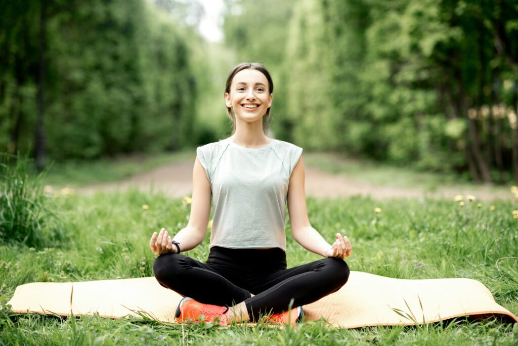 Young woman doing yoga in the park